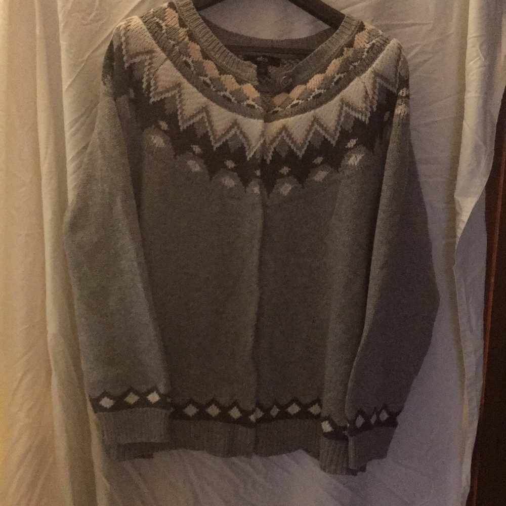 Ellos warm sweater with snap buttons and knit details.
